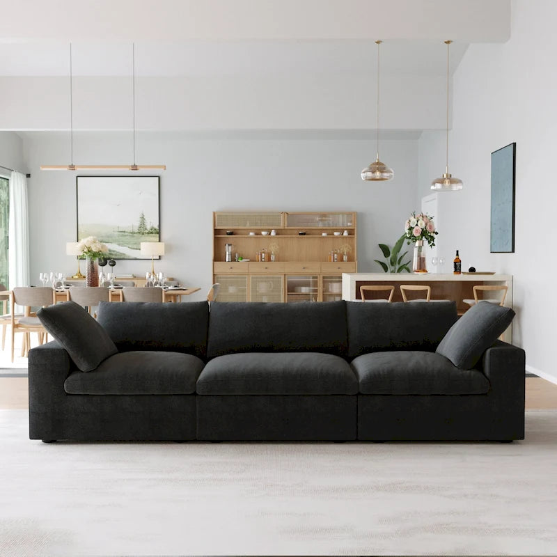 Canapé d’angle noir généreusement rembourré de duvet avec pouf