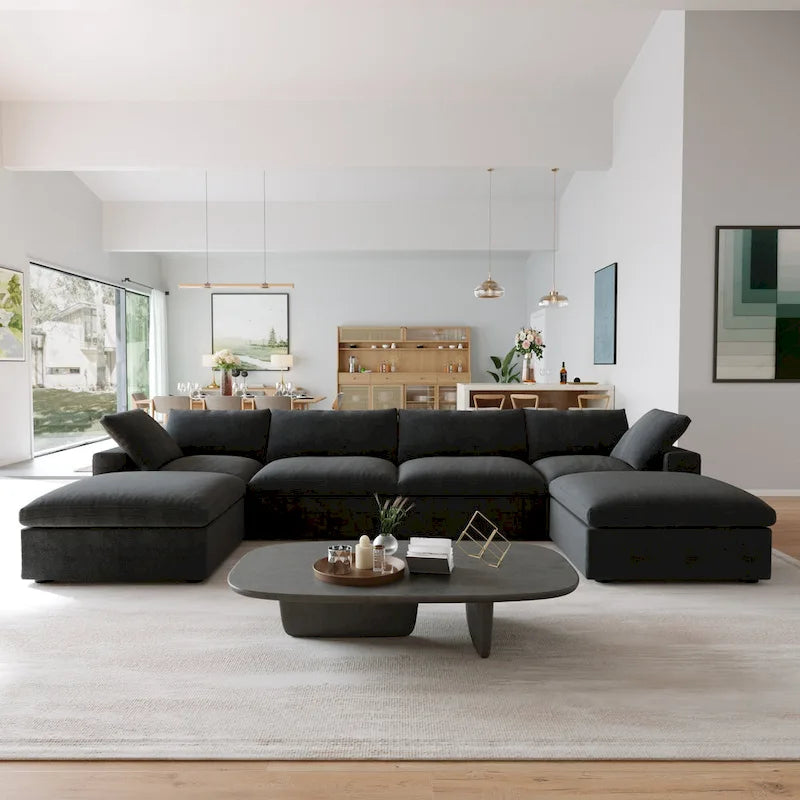 Canapé d’angle noir généreusement rembourré de duvet avec pouf